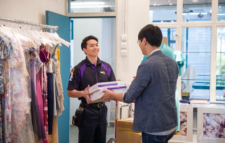 a Logistics Center driver handing over a package